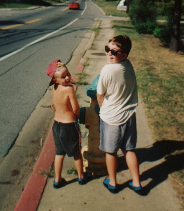 Scott walking down a sidewalk with his younger brother, Robert.